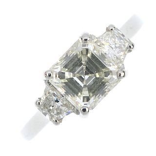 A platinum diamond single-stone ring. The Asscher-cut diamond, with fancy-cut diamond sides, to the