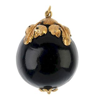 A late 19th century mounted seed pendant. The polished Caribbean drift seed, with foliate cap and te