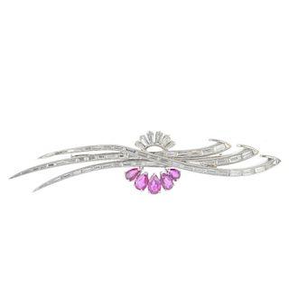 A diamond and ruby brooch. Designed as three baguette-cut diamond overlapping lines, with tapered ba