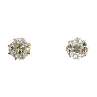 A pair of diamond single-stone ear studs. Each designed as an old-cut diamond, within a claw setting
