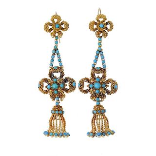 A pair of turquoise ear pendants. Each designed as a beaded stylised bow and fringe, suspended from