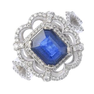 An 18ct gold sapphire and diamond dress ring. The rectangular-shape sapphire, within a brilliant-cut