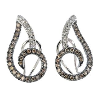 A pair of diamond earrings. Each designed as a brilliant-cut diamond and 'brown' brilliant-cut diamo