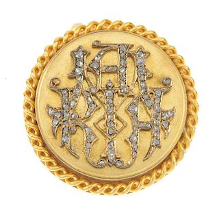 A late 19th century gold diamond brooch. The rose-cut diamond monogram, within a rope-twist surround