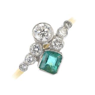 An emerald and diamond dress ring. Designed as two graduated brilliant-cut diamond crossover lines,