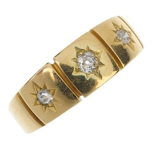 A late Victorian 18ct gold diamond three-stone ring. The graduated old and single-cut diamond star l