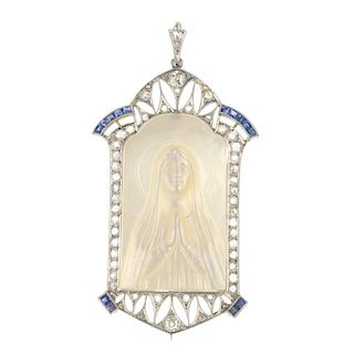 A mother-of-pearl, synthetic sapphire and diamond pendant. The mother-of-pearl panel, carved to depi