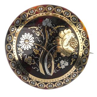 A late 19th century pique tortoiseshell brooch. The foliate motif, within a geometric border. Diamet