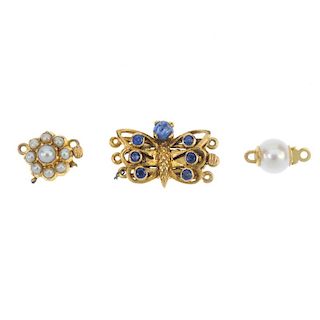 A selection of three clasps. To include a sapphire butterfly clasp, a mid 20th century split pearl f