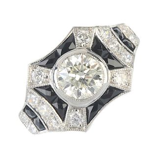 A diamond and onyx dress ring. The brilliant-cut diamond collet, within a calibre-cut black onyx and