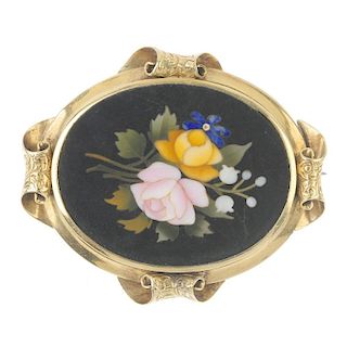 A gold pietra dura brooch. Of oval outline, the floral hardstone panel, within a scrolling foliate e