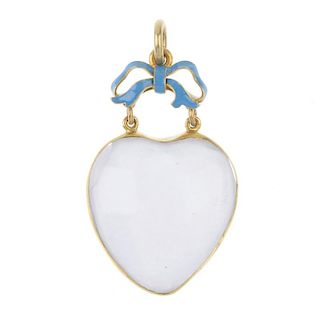 A late 19th century gold rock crystal enamel and quartz heart pendant. The heart-shape rock crystal