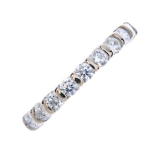 An 18ct gold diamond half-circle eternity band. The brilliant-cut diamond line, with bar spacers, to