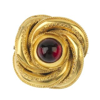 A late 19th century paste brooch. The replacement red paste cabochon, within a cannetille stylised k
