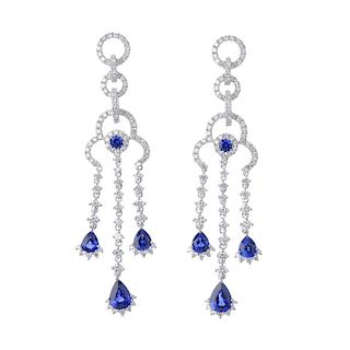 * A pair of sapphire and diamond ear pendants. Of openwork design, the circular-shape sapphire and b