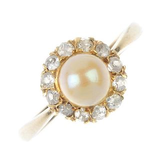A pearl and diamond cluster ring. The yellow pearl, within an old-cut diamond surround, to the sligh