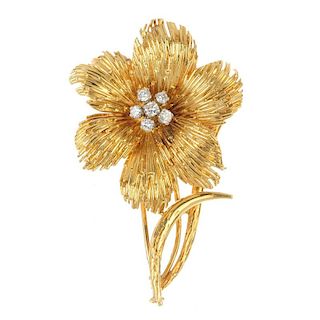 A mid 20th century diamond flower brooch. The brilliant-cut diamond cluster, within a textured petal