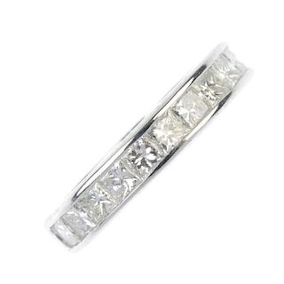 A diamond full-circle eternity ring. The square-shape diamond, within a channel setting to the plain