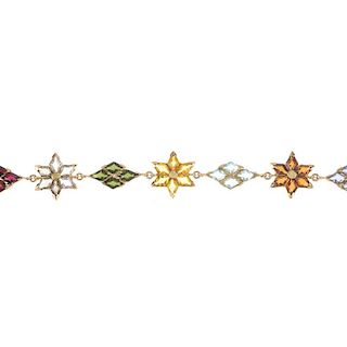 A multi-gem and paste bracelet. Designed as a series of lozenge-shape mutli-gem and paste flowers, t