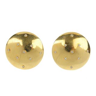 A pair of mid 20th century diamond earrings. Each designed as a domed disc, with overlaid scattered