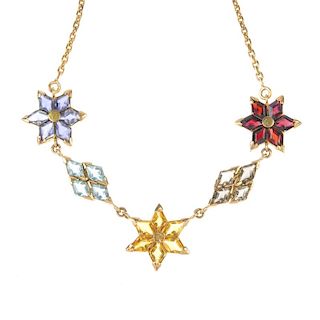 A multi-gem and paste necklace. Designed as a series of lozenge-shape gem-set and paste flowers, to