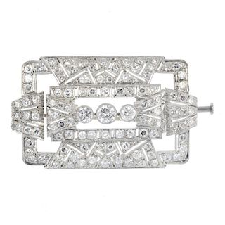 A mid 20th century diamond brooch. The graduated brilliant-cut diamond collet line, to the single-cu