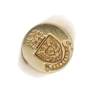 An 18ct gold signet ring. The oval-shape panel, with reverse intaglio engraving depicting an armoria