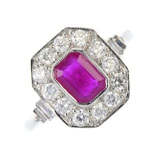 A ruby and diamond cluster ring. The rectangular-shape ruby, within a brilliant-cut diamond surround