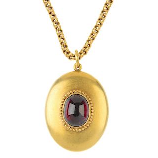 A late 19th century gold garnet pendant and chain. The oval garnet cabochon, within a beaded border,