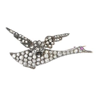 A late 19th century silver and gold diamond and gem-set bird brooch. Designed to depict a duck in fl