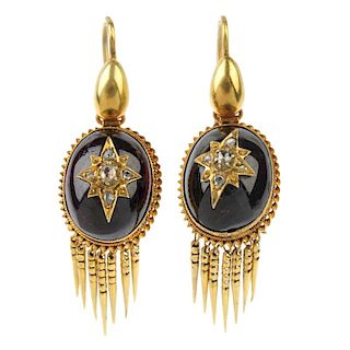 A pair of late 19th century garnet and diamond ear pendants. Each designed as an oval garnet cabocho