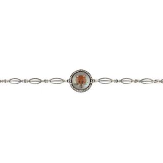 An early 20th century platinum and 15ct gold reverse intaglio fox bracelet. Depicting a fox head, wi