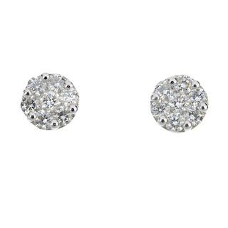 A pair of 18ct gold diamond cluster ear studs. Each designed as a brilliant-cut diamond, within a si