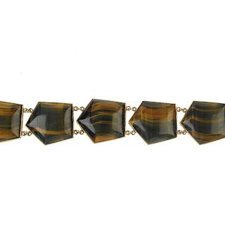 A tiger's-eye bracelet. Designed as a series of angular tiger's-eye links, to the push-piece clasp.