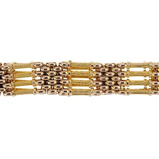 An early 20th century 15ct gold gate bracelet. The grooved four-row links, with brick-link spacers,