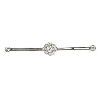 An early 20th century diamond bar brooch. The old-cut diamond scalloped cluster, to the twin bar sid