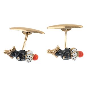 A pair of mid 20th century enamel and coral blackamoor cufflinks. Each designed as a black and white