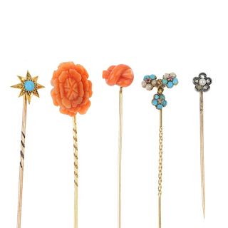 A selection of five late 19th to early 20th century gold stickpins. To include a carved coral flower