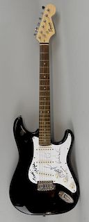 Fender Squier Strat guitar signed on the scratch plate by Paul McCartney, Pete Townshend, Bob Geldof