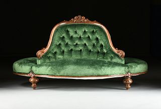 A VICTORIAN GREEN VELVET UPHOLSTERED AND CARVED WALNUT CONFIDANTE, MID 19TH CENTURY,