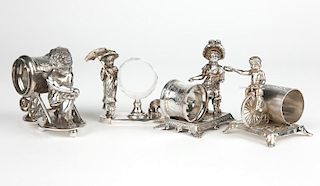 4 Victorian figural silver-plated napkin rings