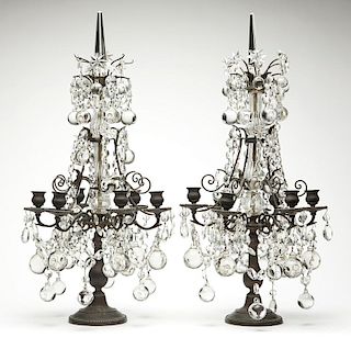 A pair of patinated metal and crystal girandoles