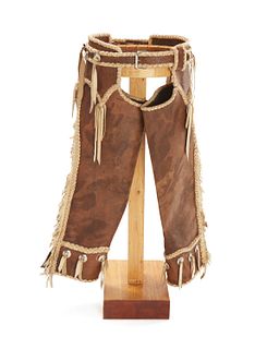 A pair of rope and concho accented chaps