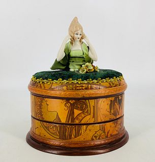 Artisan designed sewing box. 9 1/2" high overall, china half doll tops oval box with art nouveau design, opens to reveal two inner compartments that h