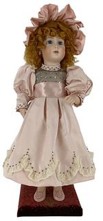 Reproduction Jumeau automaton. 20" doll with mohair wig, stationary glass eyes, pierced ears, on body affixed to velvet platform. Key wind mechanism i