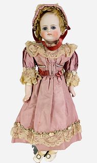 Kestner bisque turned shoulder head girl. 17 1/2" solid dome doll with mohair wig, stationary glass eyes, closed mouth, on gusseted kid body with bisq