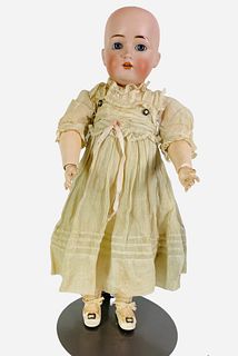J.D.K. 214 bisque socket head girl. 17" doll with glass sleep eyes, open mouth with teeth, on jointed composition body. Bisque has no apparent damage,