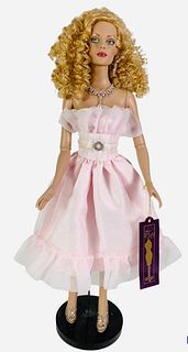 16" Tonner Tyler Wentworth Collection doll wearing a pink ruffle dress and pink shoes. Has hand tag. No Box.