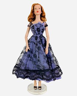 16" Tonner doll dressed in a periwinkle dress with black lace and shoes. In great condition. No box.
