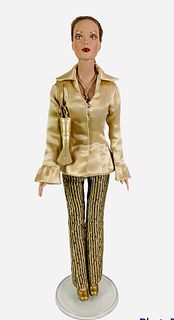 16" Tonner doll, redressed in gold blouse and gold and brown stripe pants, gold purse and shoes. No box.